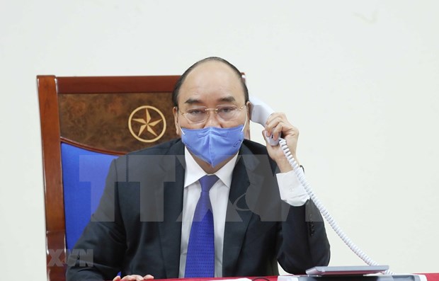 Premieres vietnamita y china sostienen conversaciones telefonicas sobre la cooperacion contra COVID-19 hinh anh 1