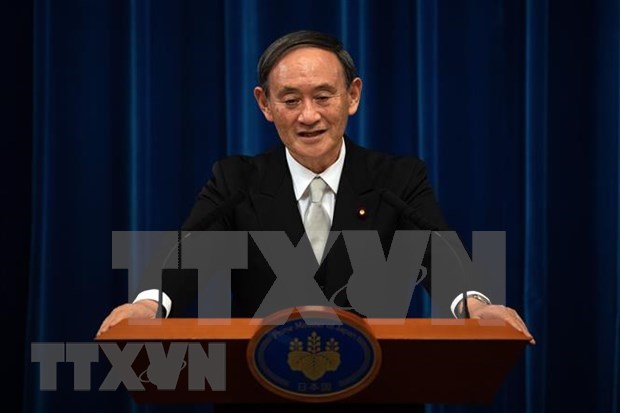 Inicia primer ministro japones visita oficial a Vietnam hinh anh 1