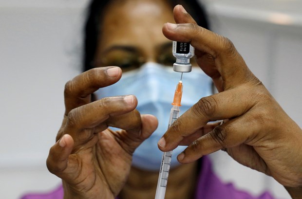 Singapur lidera el mundo en tasa de cobertura de vacunas contra COVID-19 hinh anh 1