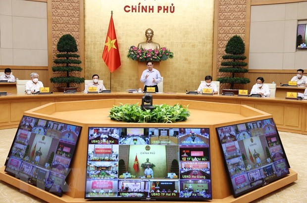 Premier vietnamita destaca importancia de lucha contra el COVID-19 a nivel de base hinh anh 1
