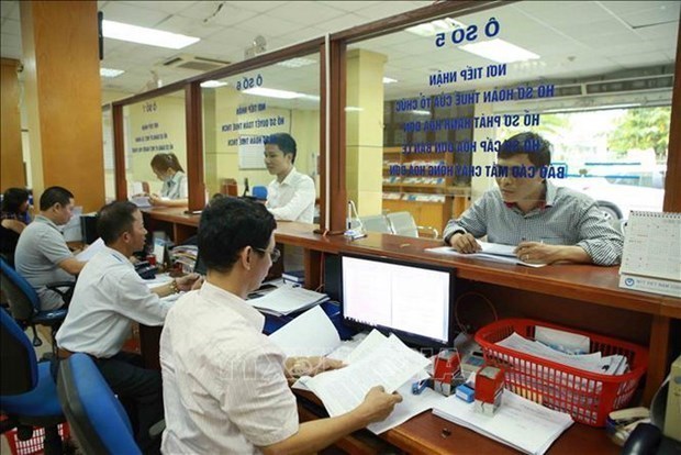 Alivio tributario para las empresas vietnamitas afectadas por el COVID-19 hinh anh 1