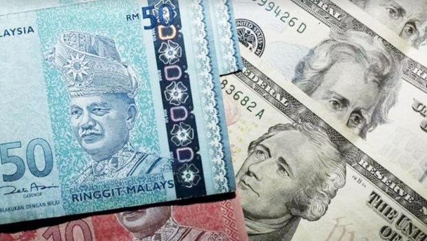 Malasia trabaja para fortalecer la moneda local hinh anh 1